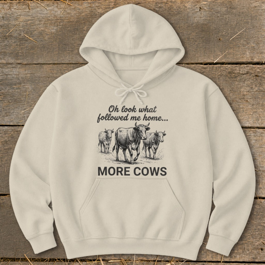 Cream hoodie with sketch of cows and text "MORE COWS".