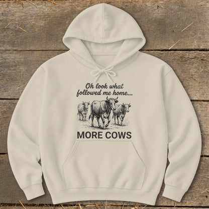 Cream hoodie with sketch of cows and text "MORE COWS".