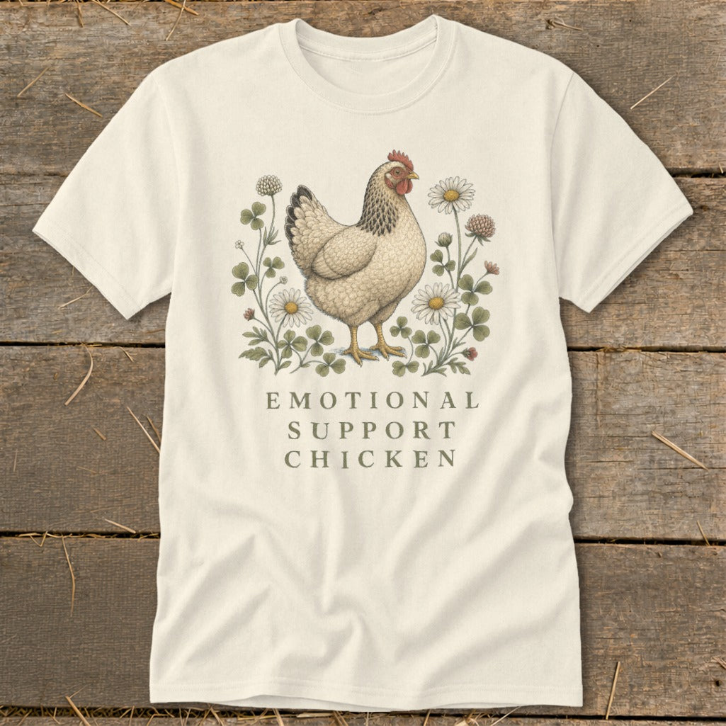 Cream t-shirt with a chicken illustration surrounded by clover and daisies, reading "Emotional Support Chicken."