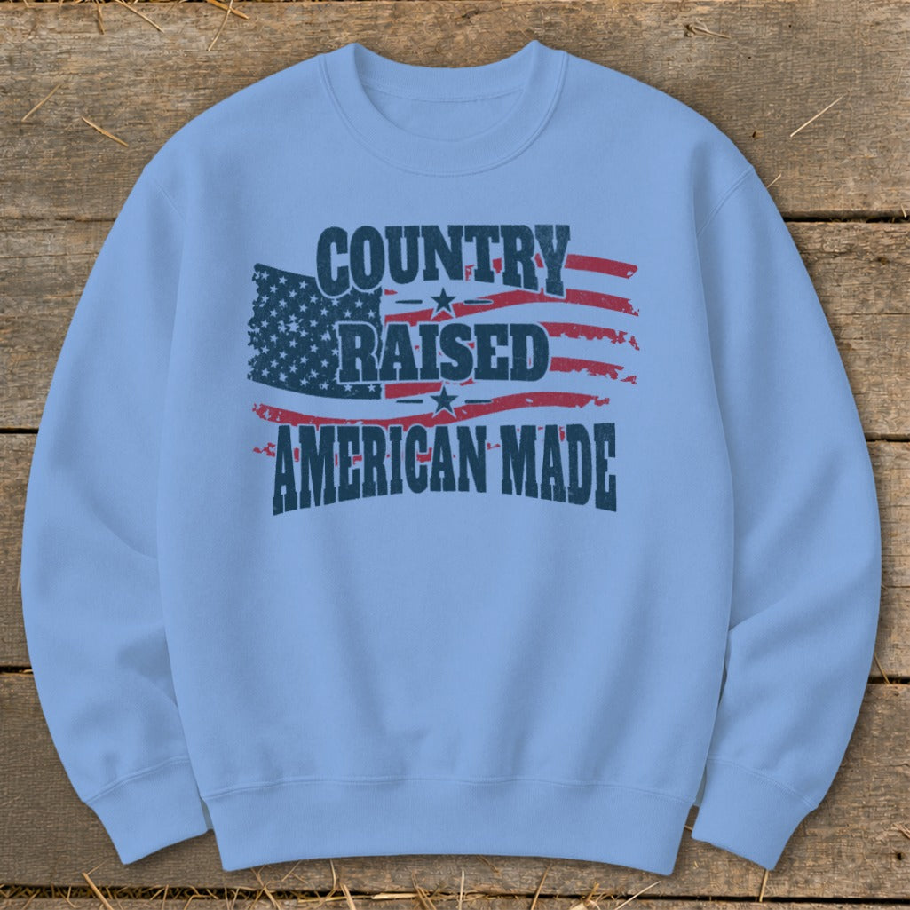 Light blue sweatshirt with "Country Raised American Made" text and distressed American flag graphic.
