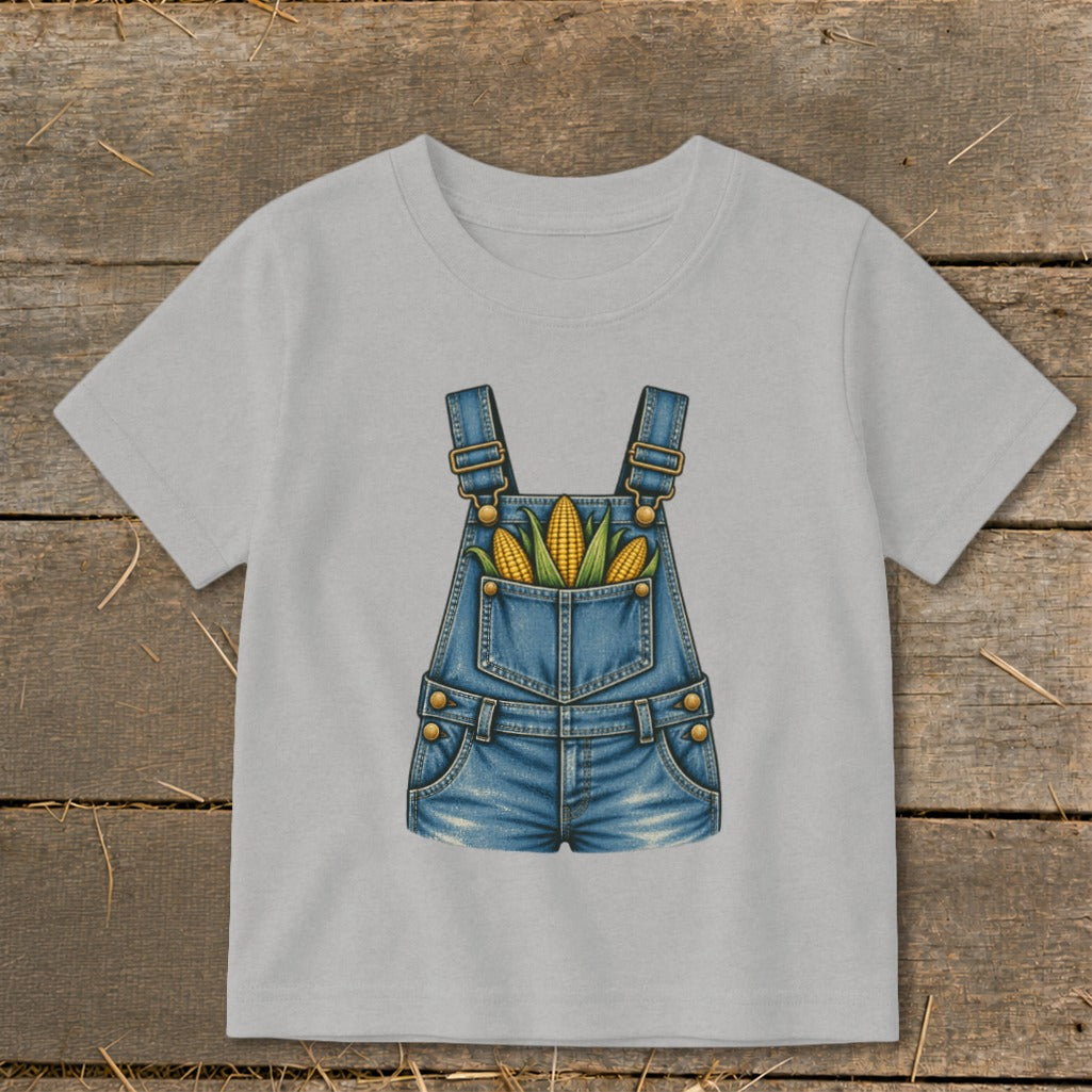 Light grey t-shirt with a denim overalls graphic filled with corn.