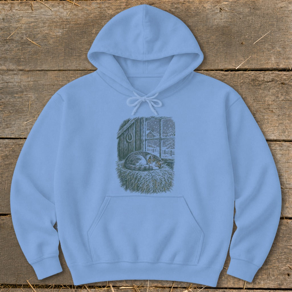 Light blue hoodie with a drawing of a sleeping cat in a barn during a snowfall.