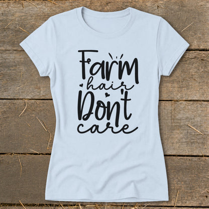 Light blue t-shirt with "Farm hair don't care" in black script.