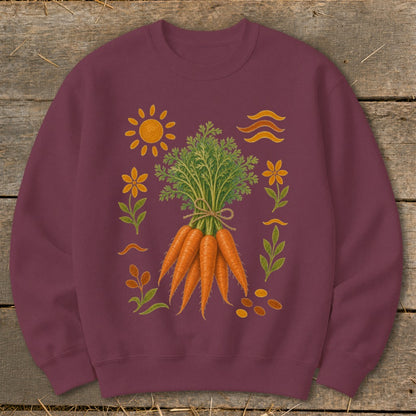 Burgundy sweatshirt with a print of a bunch of carrots, sun, flowers, and wavy lines.