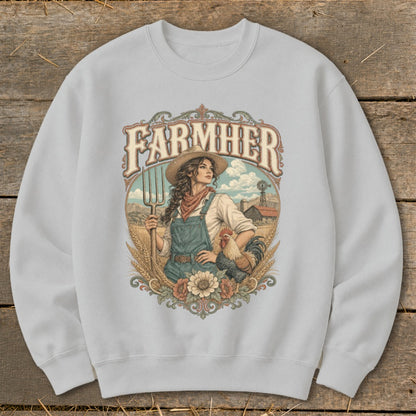 "FarmHer" graphic on a sweatshirt depicting a woman with a pitchfork, rooster, and farm background.