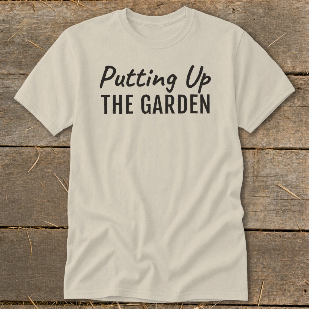 Cream t-shirt with black text that says "Putting Up THE GARDEN".