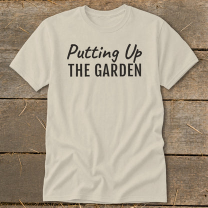Cream t-shirt with black text that says "Putting Up THE GARDEN".
