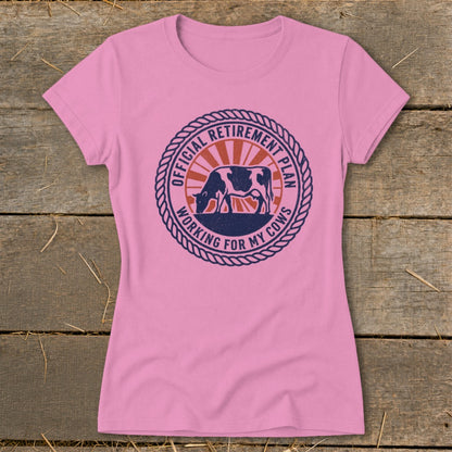 Pink t-shirt with circular graphic: cow, sunburst, "Official Retirement Plan Working for My Cows".