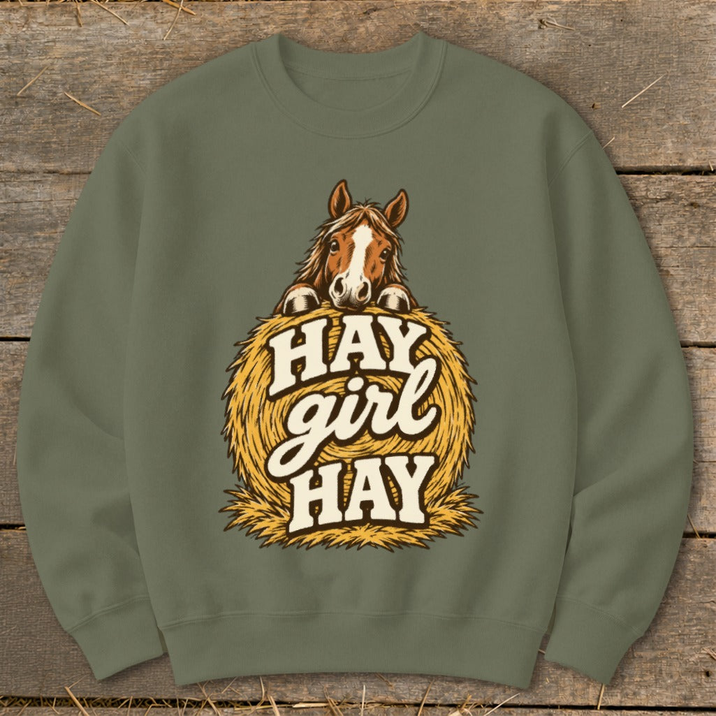 Green sweatshirt with a horse peeking over a hay bale with text "Hay Girl Hay".
