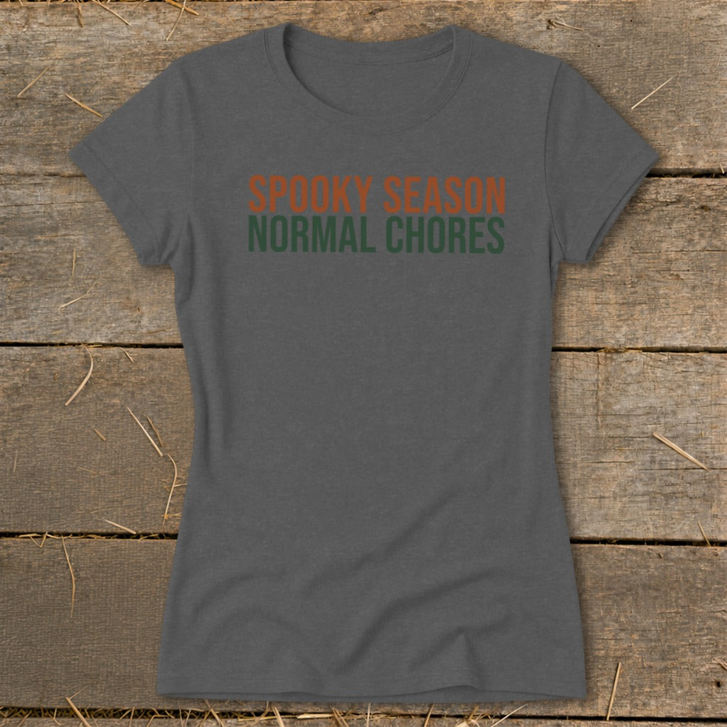Charcoal t-shirt with orange and green text reading "Spooky Season Normal Chores".