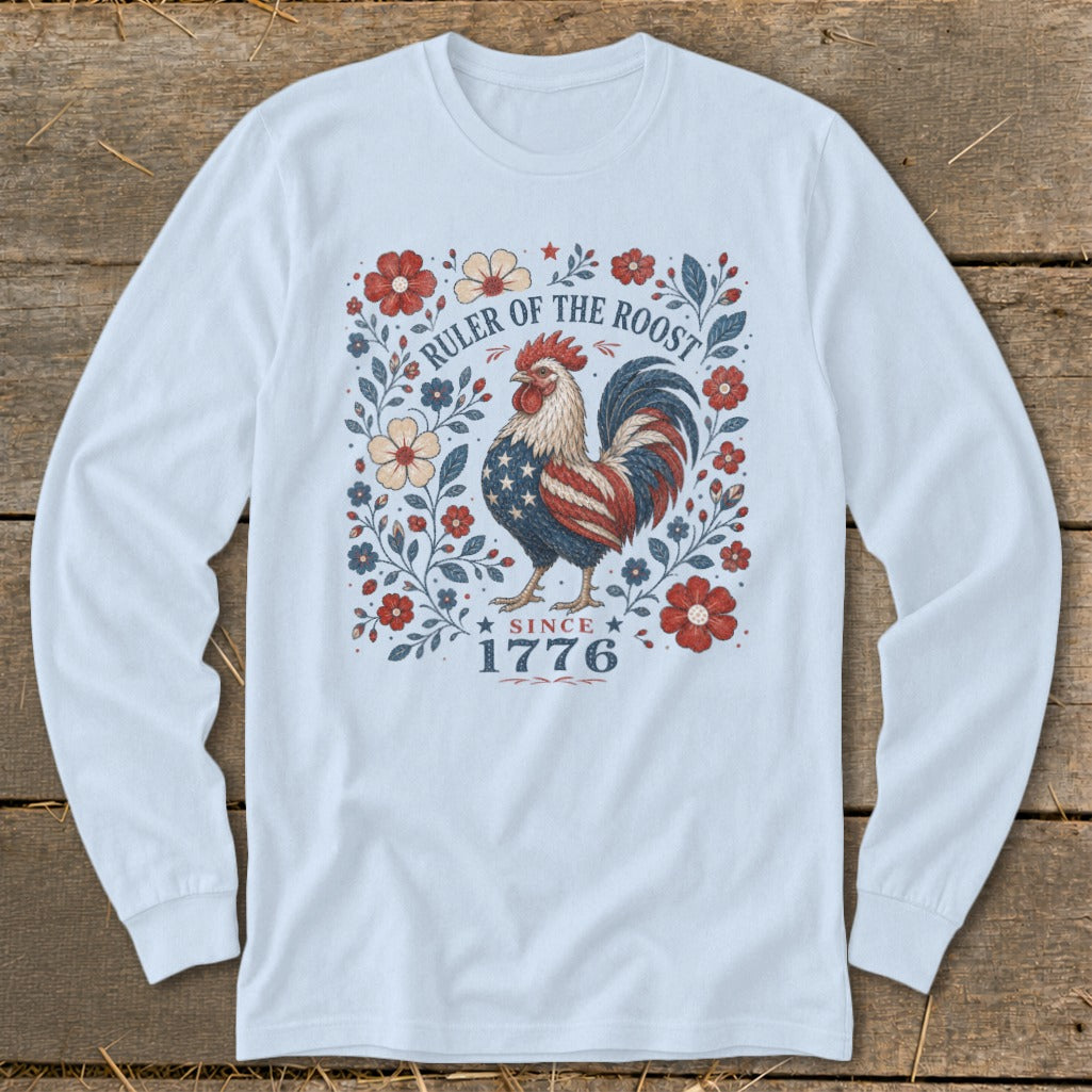 Rooster with American flag design on a light blue long-sleeve shirt with floral border and "Since 1776" text.