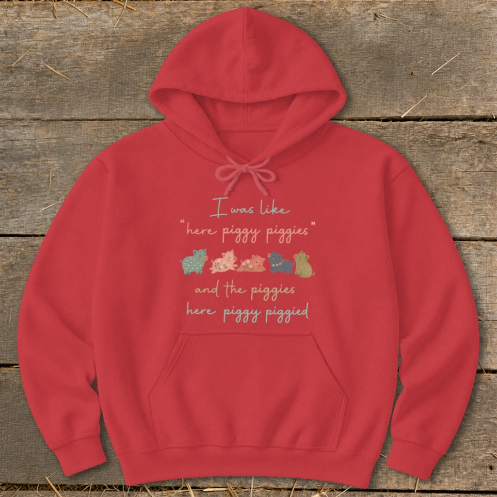 Red hoodie with text "I was like 'here piggy piggies' and the piggies here piggy piggied" and row of small pigs.