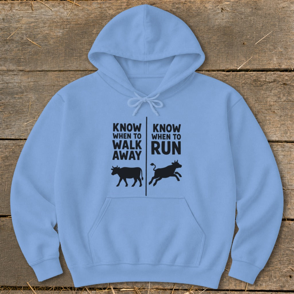 Light blue hoodie with text "Know When to Walk Away" and "Know When to Run" with cow graphics.
