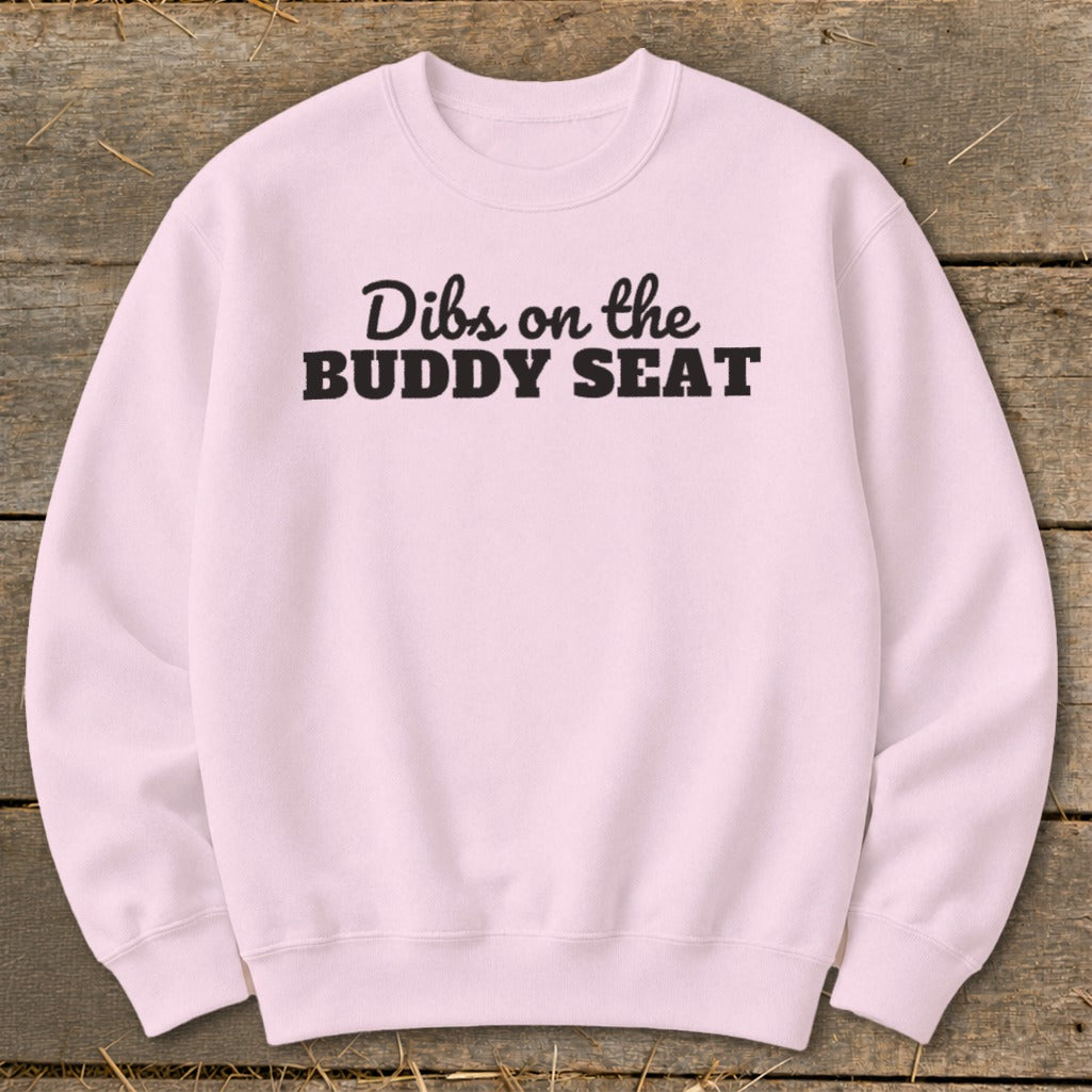 Pink sweatshirt with black text that reads "Dibs on the BUDDY SEAT".