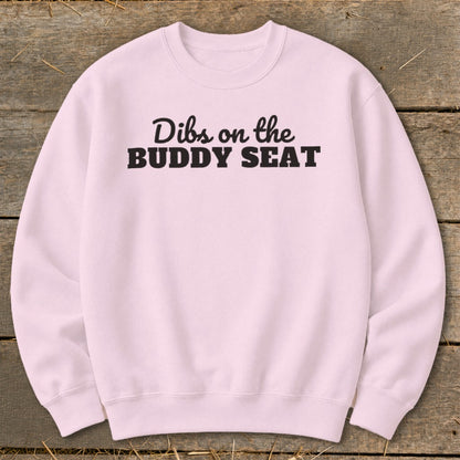 Pink sweatshirt with black text that reads "Dibs on the BUDDY SEAT".