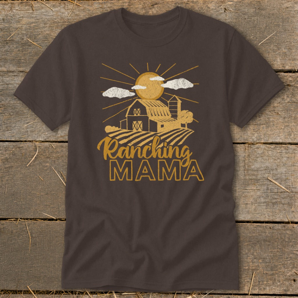 Brown t-shirt with gold text and graphic of a barn, fields, sun, and clouds.