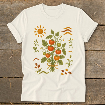 Cream t-shirt with a vine of ripe tomatoes, sun, and seed graphic.
