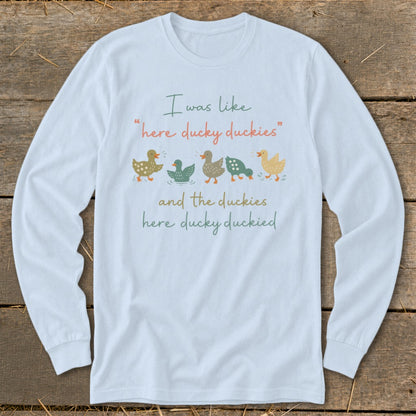 Light blue long-sleeve shirt with duck illustrations and text about duckies.