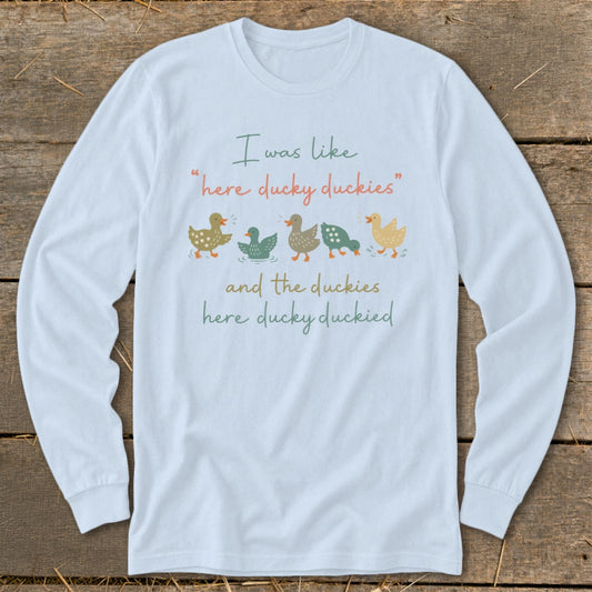 Light blue long-sleeve shirt with duck illustrations and text about duckies.
