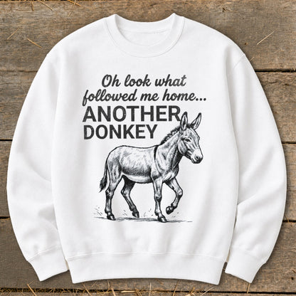 White sweatshirt with a drawing of a donkey and the text "Oh look what followed me home... ANOTHER DONKEY".