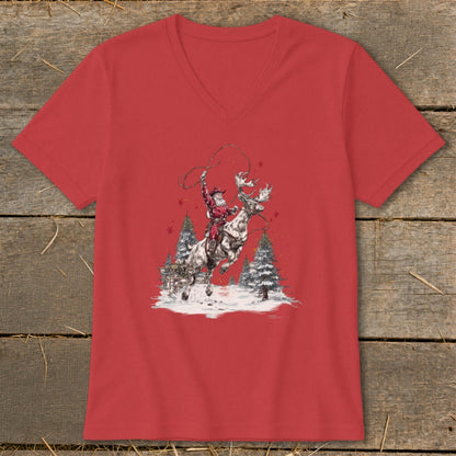 Red t-shirt featuring Santa riding a reindeer with a lasso and snowy trees.