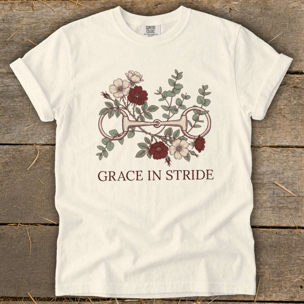 Cream t-shirt with horse bit floral graphic and "GRACE IN STRIDE" text.