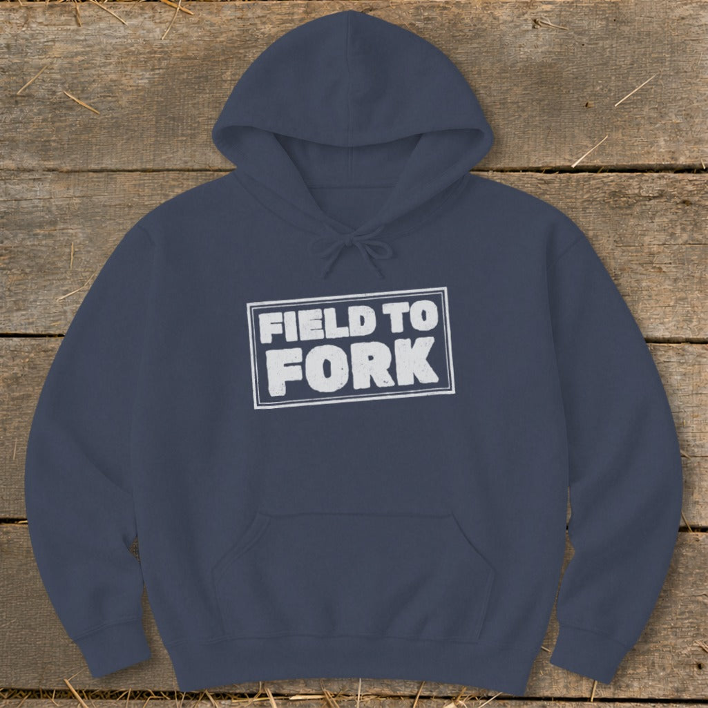 Dark blue hooded sweatshirt featuring the white distressed text FIELD TO FORK centered on the chest.