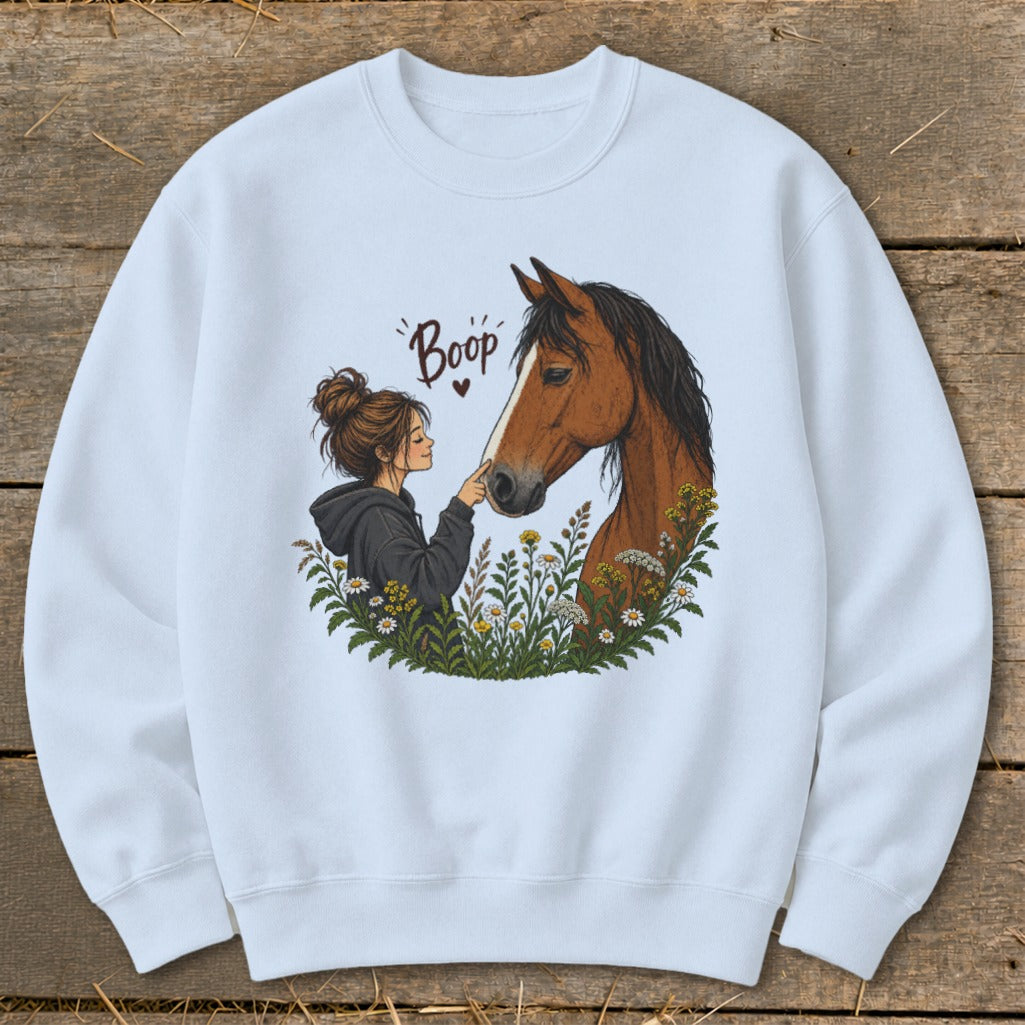 Illustration of a girl "booping" a horse's nose surrounded by wildflowers.