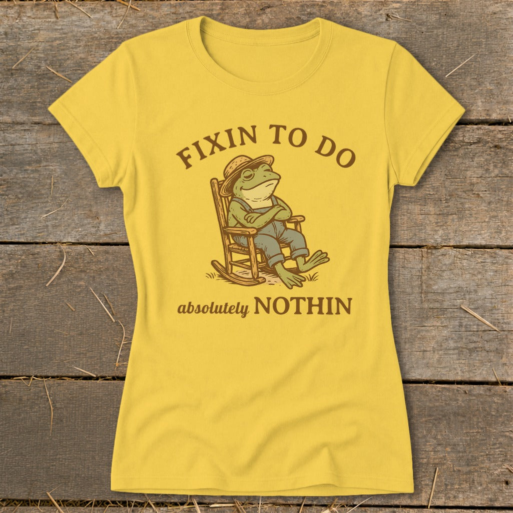 Yellow t-shirt with a frog in overalls and a hat sitting in a rocking chair.
