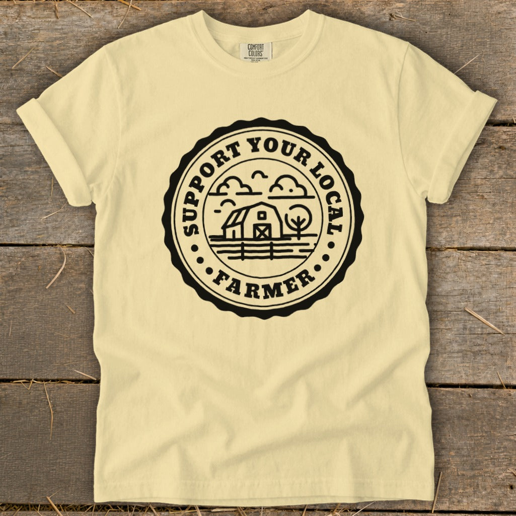 Light yellow t-shirt with black circular "Support Your Local Farmer" graphic.