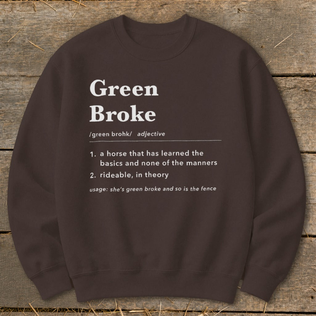 A dark brown crewneck sweatshirt featuring white dictionary-style text defining the term Green Broke.