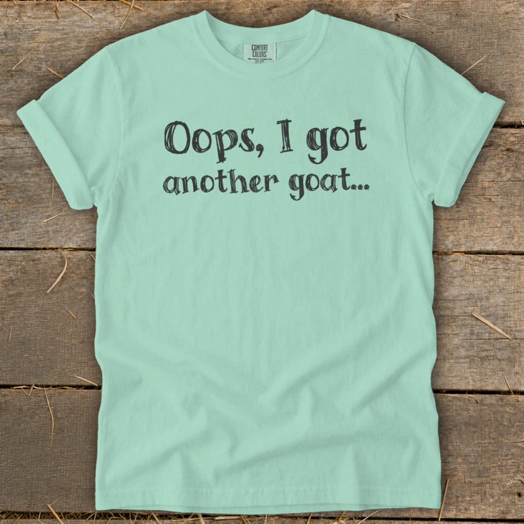 Mint t-shirt with black text reading "Oops, I got another goat...".