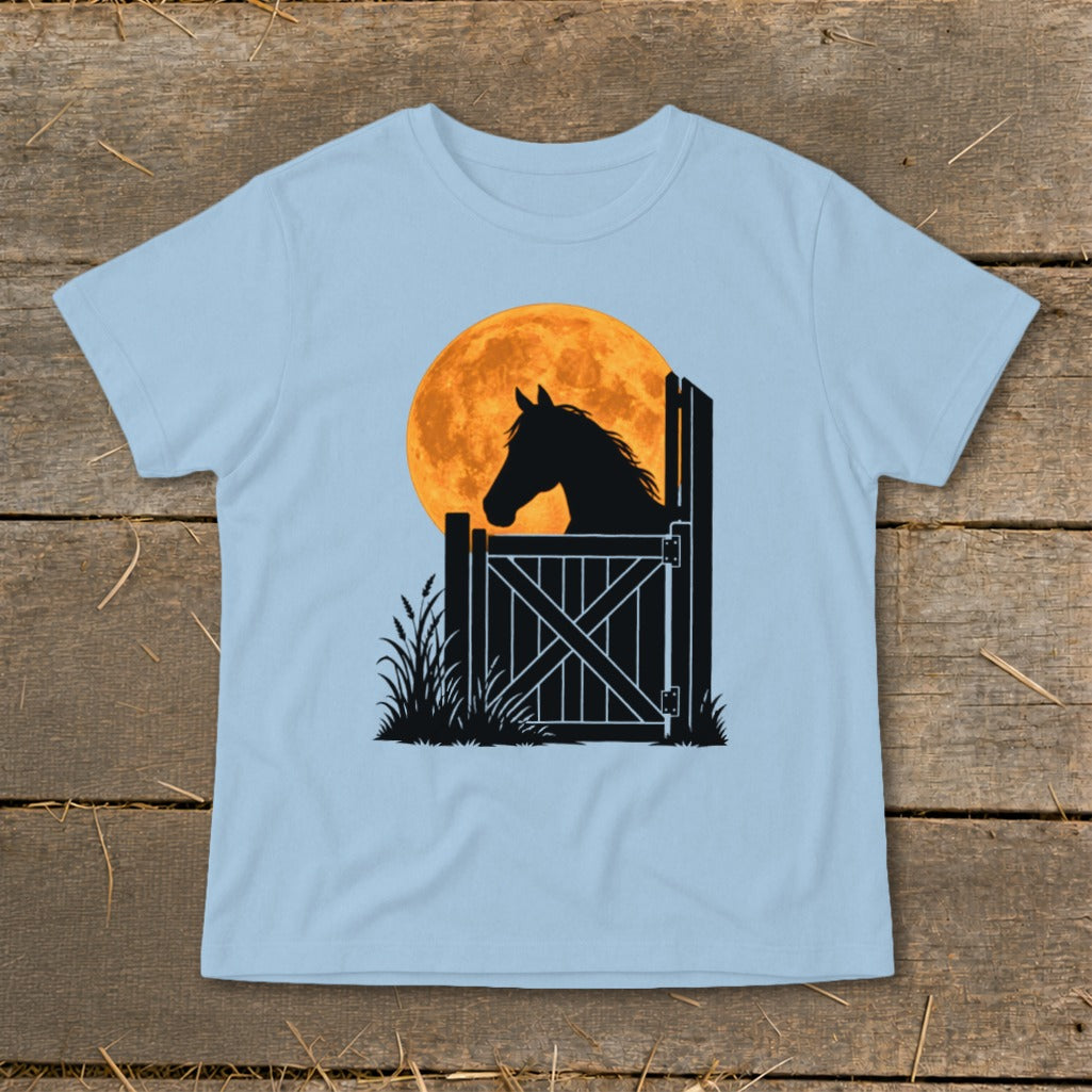 Light blue t-shirt featuring a black silhouette of a horse looking over a stable door against a large orange moon.