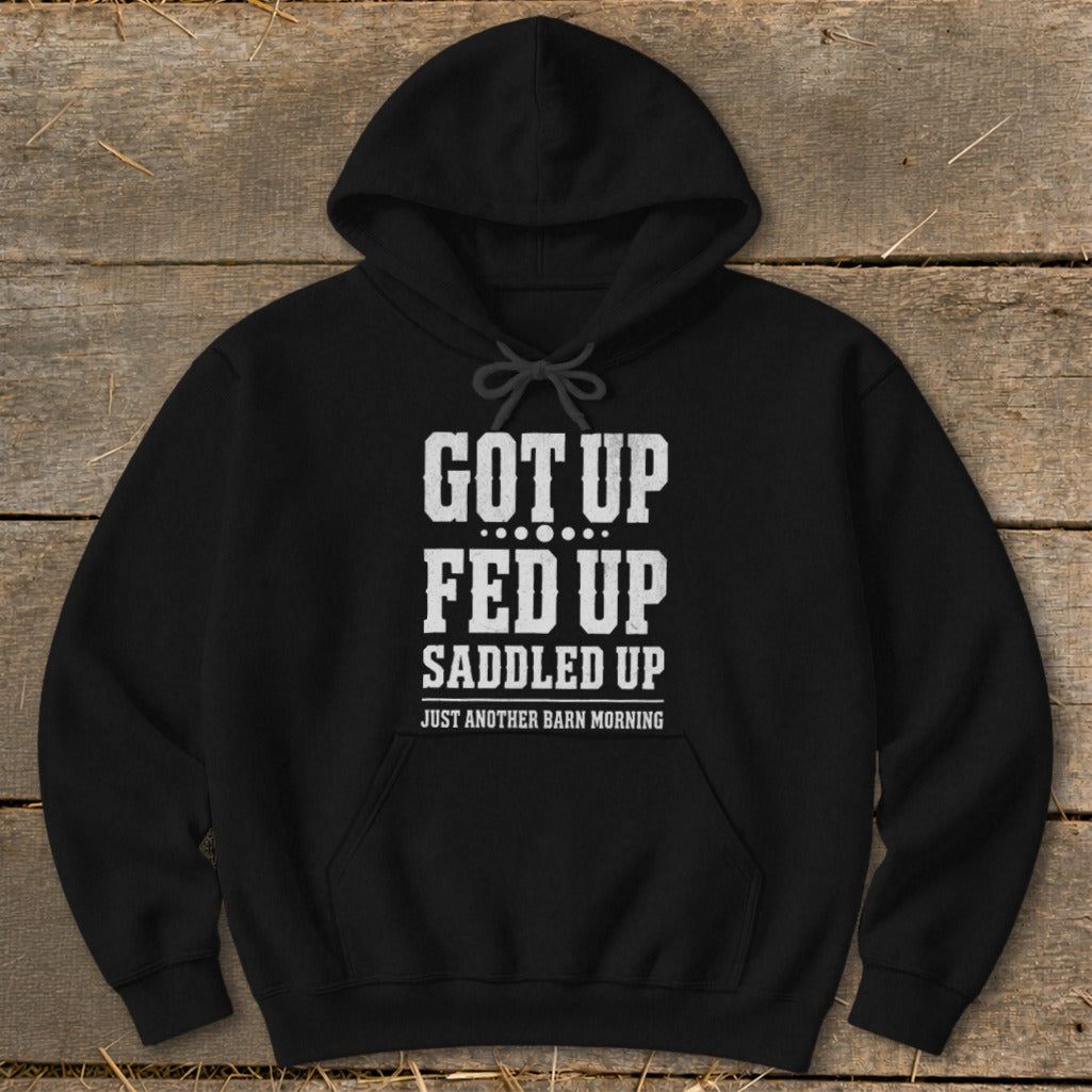 Black hoodie with white text: "GOT UP FED UP SADDLED UP JUST ANOTHER BARN MORNING"