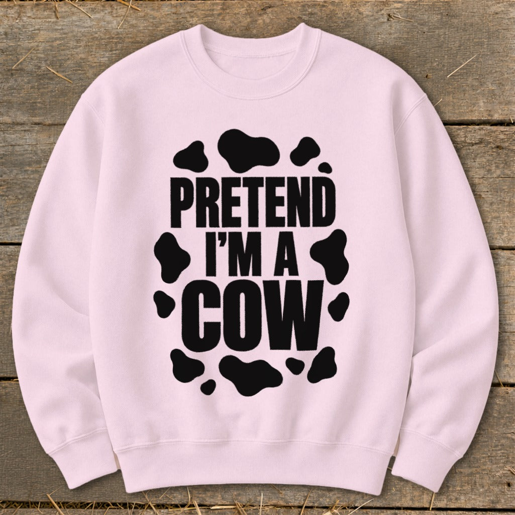 Pink crewneck sweatshirt with "PRETEND I'M A COW" text and black cow spots.