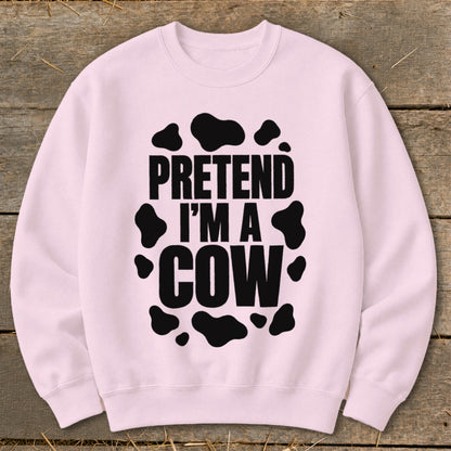 Pink crewneck sweatshirt with "PRETEND I'M A COW" text and black cow spots.