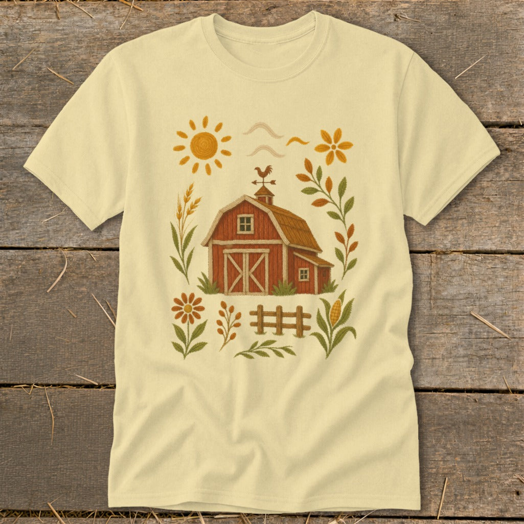 Yellow t-shirt with a cartoon farm scene featuring a red barn and sun.