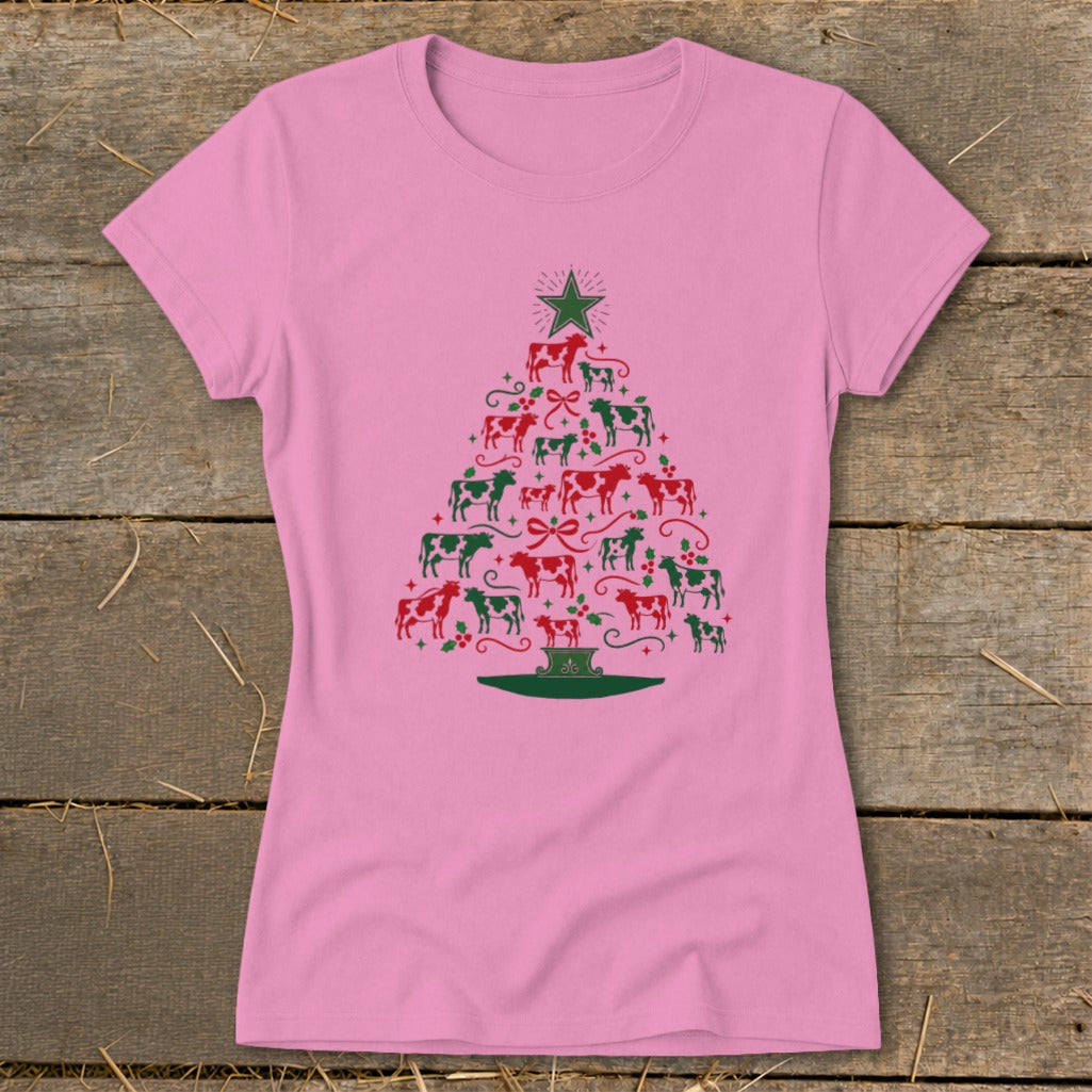 Pink t-shirt with a Christmas tree made of red and green cows and holly.