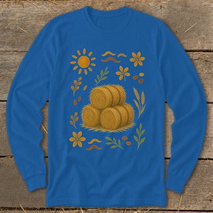 Blue long-sleeve shirt with a central stack of hay bales and autumn-themed illustrations.