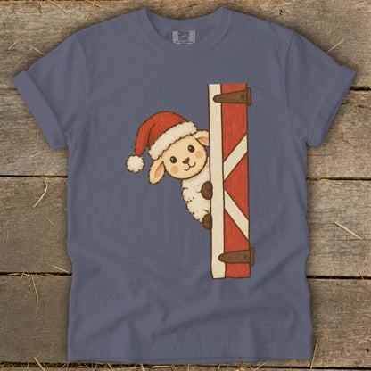 Cute sheep wearing a Santa hat peeking around a red barn door.