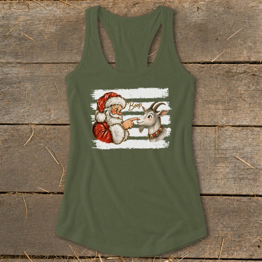 Santa playfully boops a goat on the nose with the word "Boop" on a white striped background.