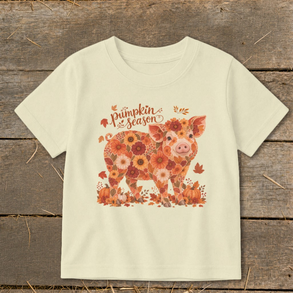 Cream t-shirt with floral pig graphic and "pumpkin season" text.