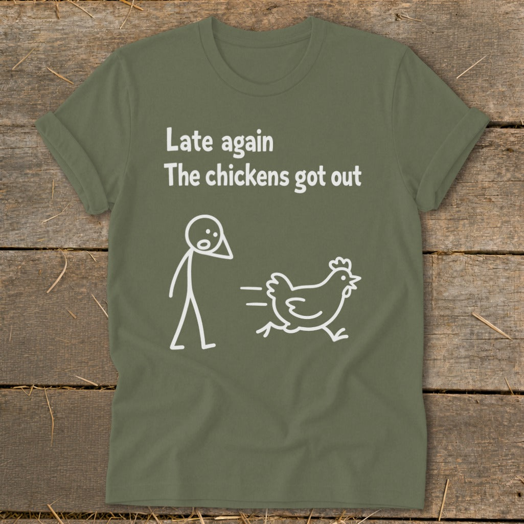 Olive green t-shirt with white text and cartoon: "Late again The chickens got out".