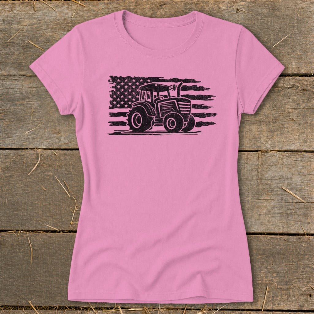 Pink t-shirt with black distressed tractor graphic superimposed on American flag.