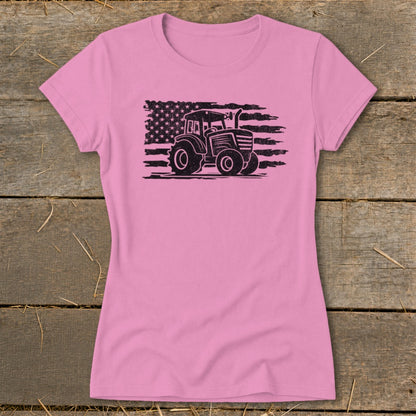 Pink t-shirt with black distressed tractor graphic superimposed on American flag.