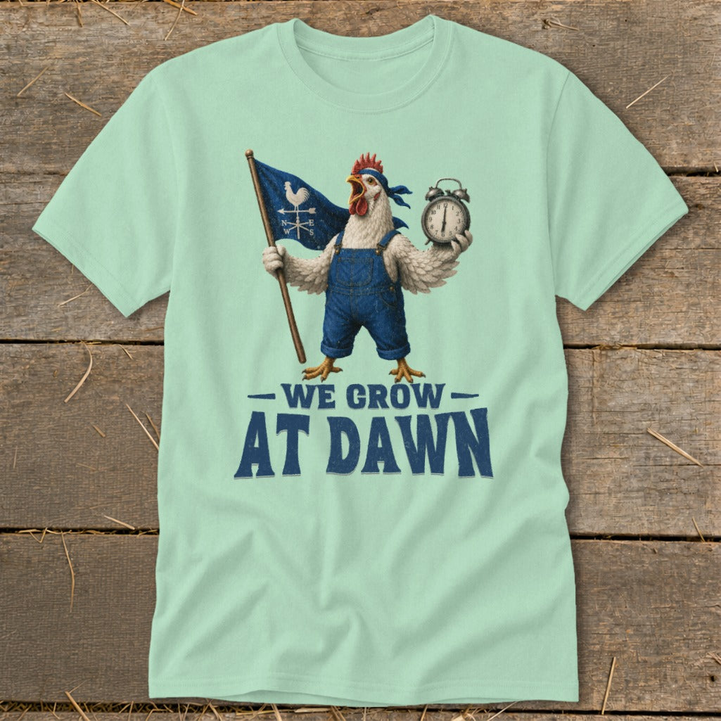 Light green t-shirt with a chicken in overalls holding a flag and alarm clock with text "WE GROW AT DAWN".