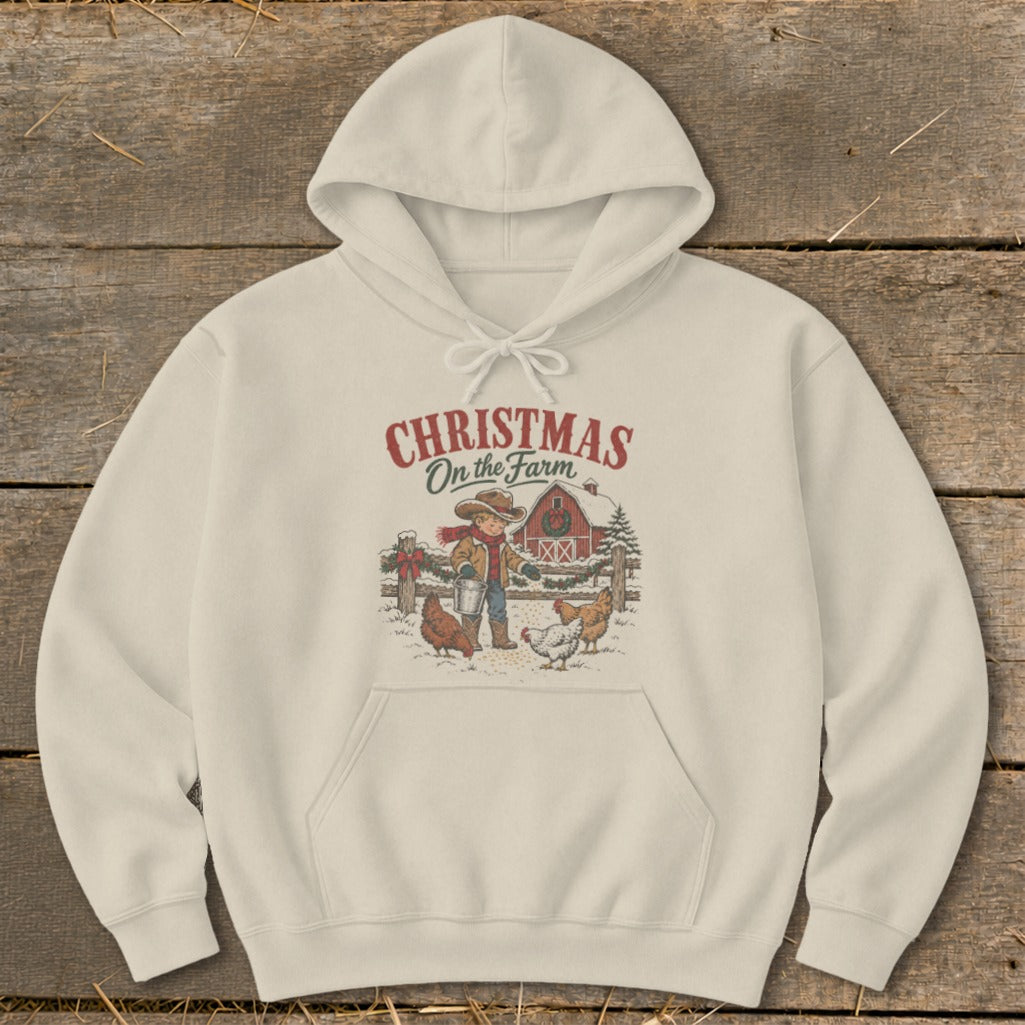 Cream hoodie with "Christmas On the Farm" graphic of boy, barn, and chickens.