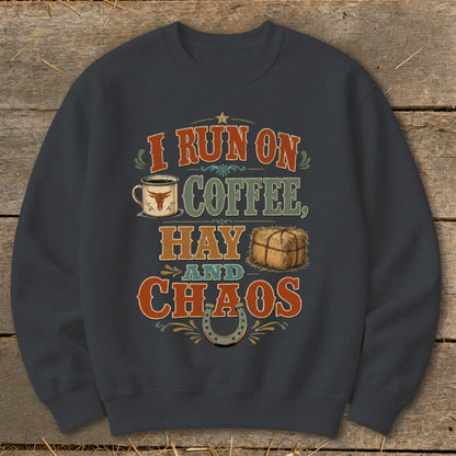 Dark gray sweatshirt with text and graphics: I run on coffee, hay and chaos.