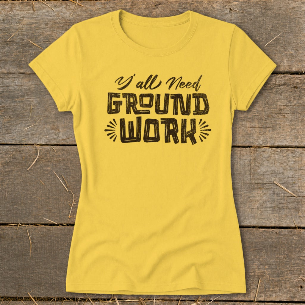 Yellow t-shirt with black text that reads "Y'all Need GROUND WORK."