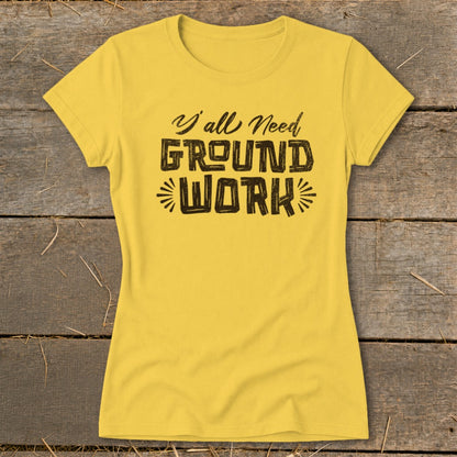Yellow t-shirt with black text that reads "Y'all Need GROUND WORK."